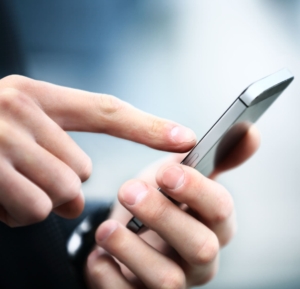 Close up of a man using mobile smart phone