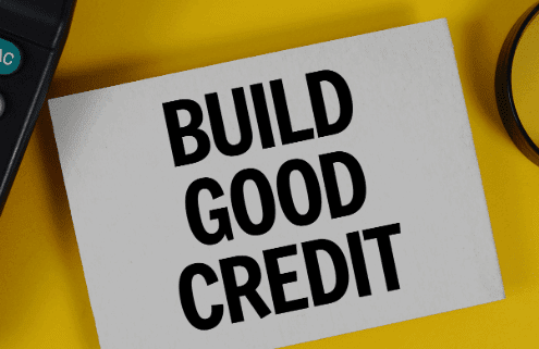 Calculator and magnifying glass on a yellow background with a sign that reads Build Good Credit.