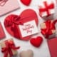 Top-down view of Valentine’s Day gift boxes in red and white with a card that reads "Happy Valentine's Day."